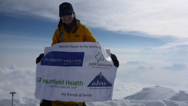 Denali summit with sponsors banner